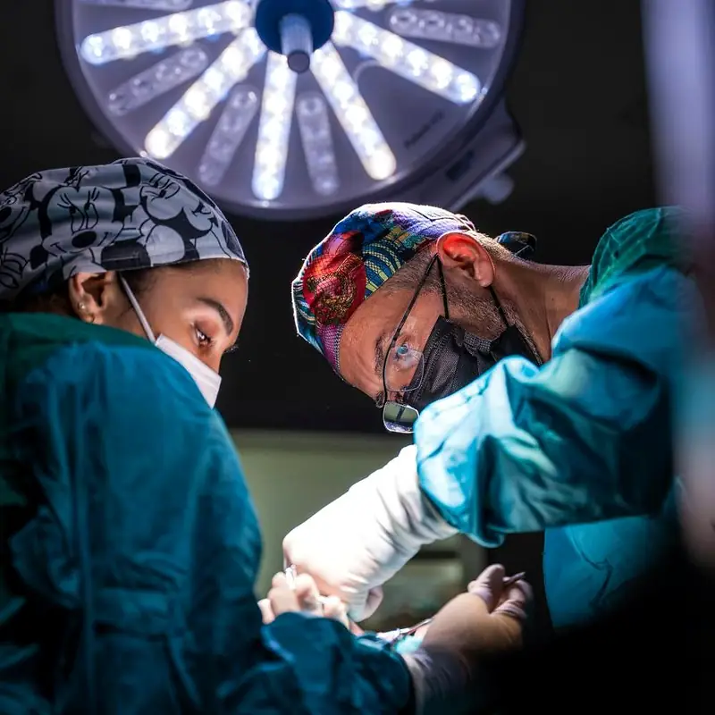 Surgical team operating under theatre lights